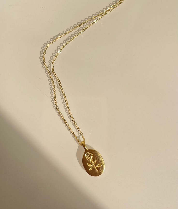 Rose engraved gold pendant